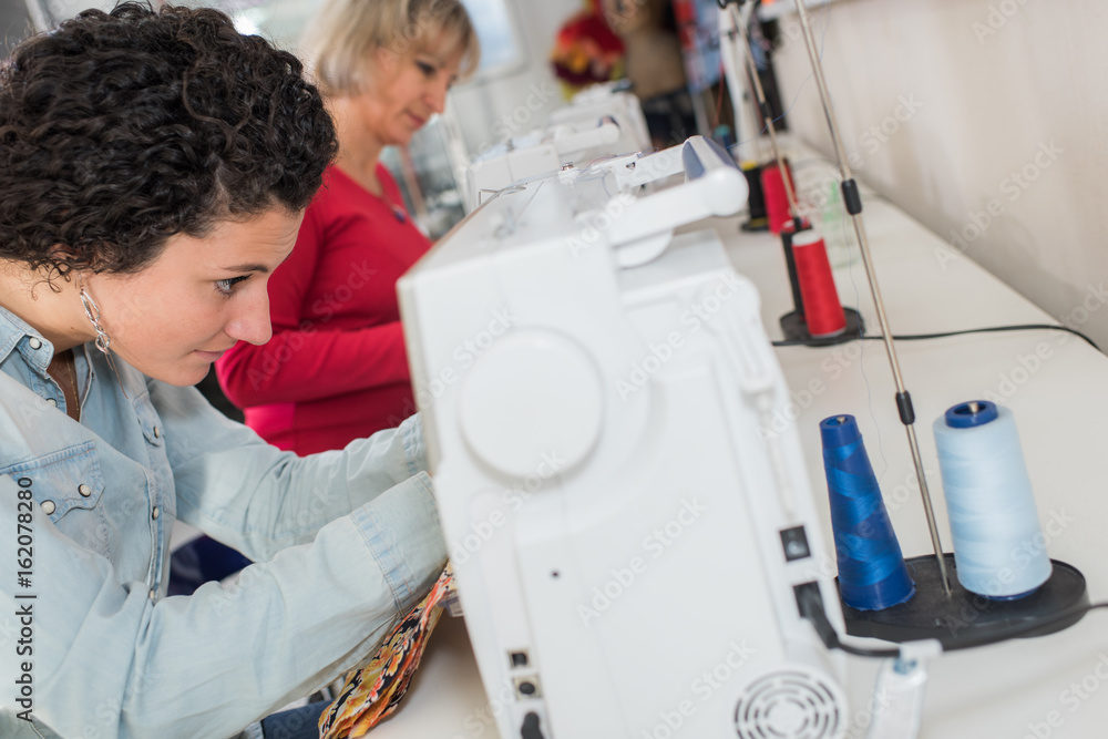 female worker on a sewing machine female worker on a sewing machine