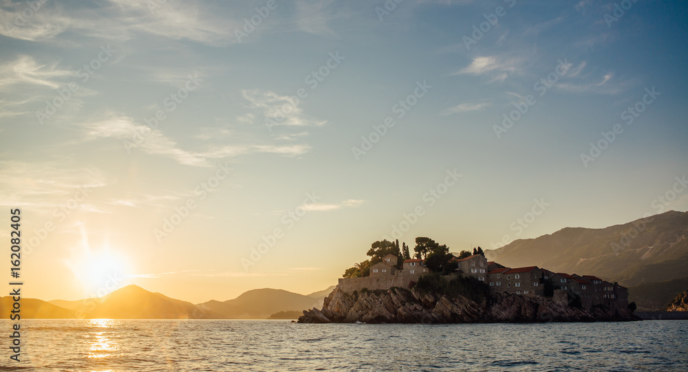 Rocky coast of the Adriatic Sea in Montenegro at sunset, view from the sea