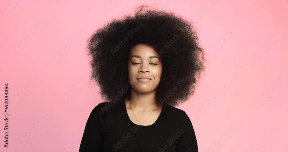 beuayt black woman with a huge afro hair having fun smiling and touching her hair beuayt black woman with a huge afro hair having fun smiling and touching her hair