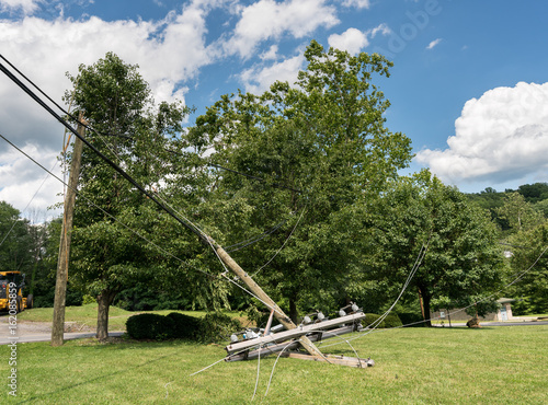 Snapped and downed power post and line after storm photo