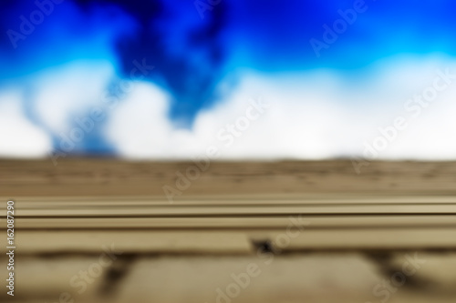 Horizontal brick wall with blue sky motion blur background