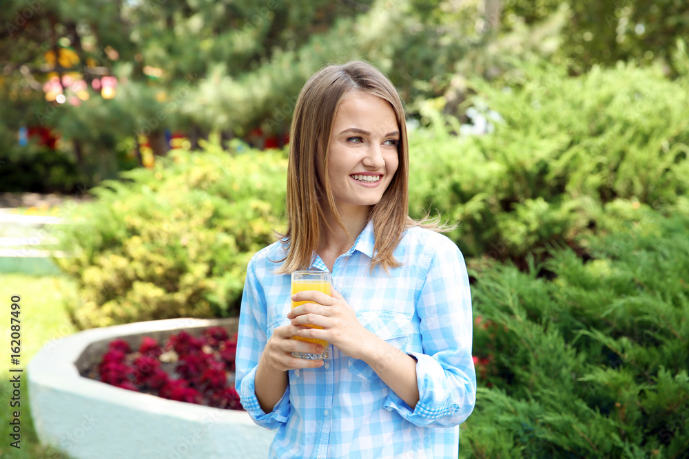 Young beautiful woman with fresh juice in park Young beautiful woman with fresh juice in park
