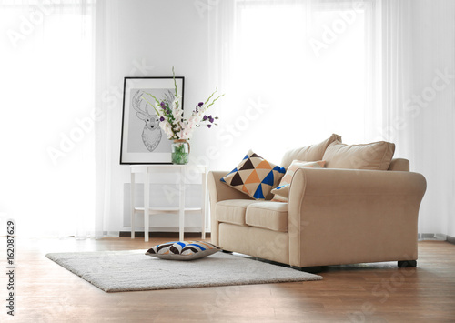 Living room interior with sofa and flowers