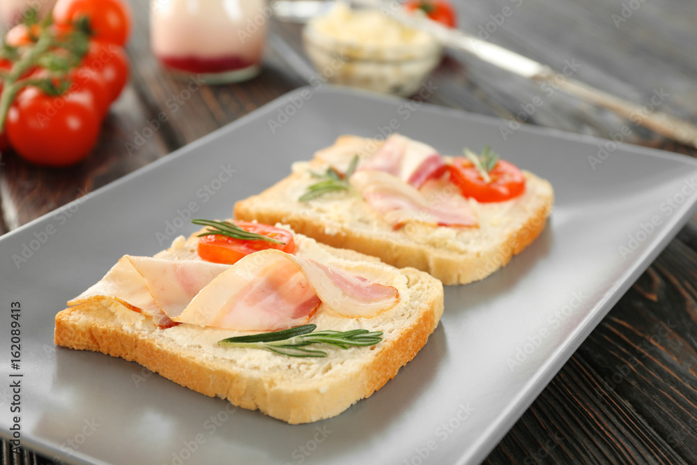 Tasty toasts with bacon for breakfast on plate Tasty toasts with bacon for breakfast on plate