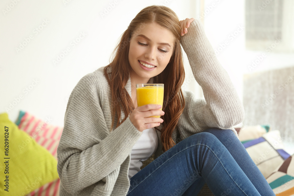 Weight loss concept. Beautiful young woman drinking healthy delicious smoothie at home Weight loss concept. Beautiful young woman drinking healthy delicious smoothie at home