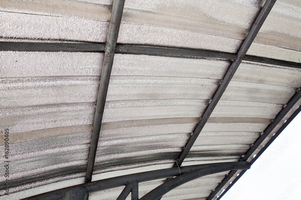 Insulating of attic with fiberglass cold barrier and reflective heat barrier isolated Insulating of attic with fiberglass cold barrier and reflective heat barrier isolated