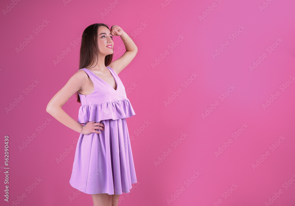 Beautiful young woman in lilac dress on color background Beautiful young woman in lilac dress on color background