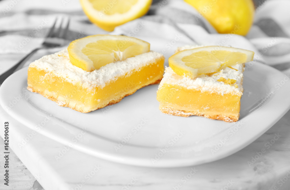 Plate with delicious lemon pie bars on table Plate with delicious lemon pie bars on table