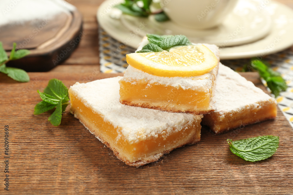 Delicious lemon pie bars on wooden board Delicious lemon pie bars on wooden board