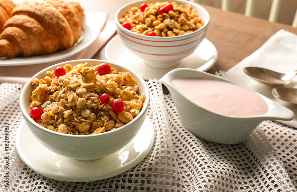 Healthy breakfast with muesli and yogurt on table Healthy breakfast with muesli and yogurt on table