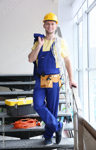 Smiling young electrician w...