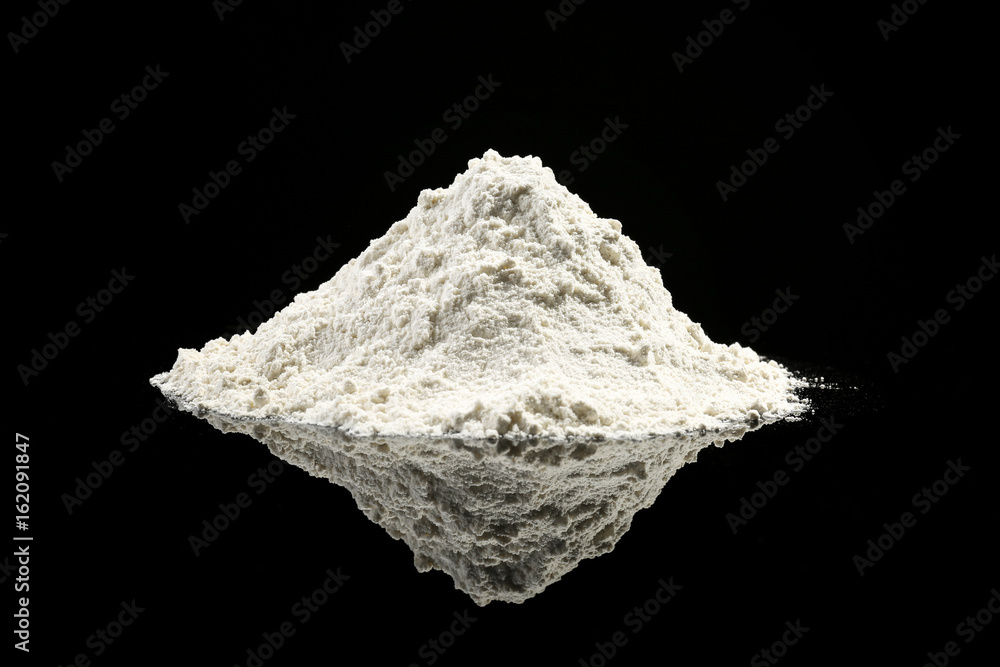 Heap of flour on black background Heap of flour on black background