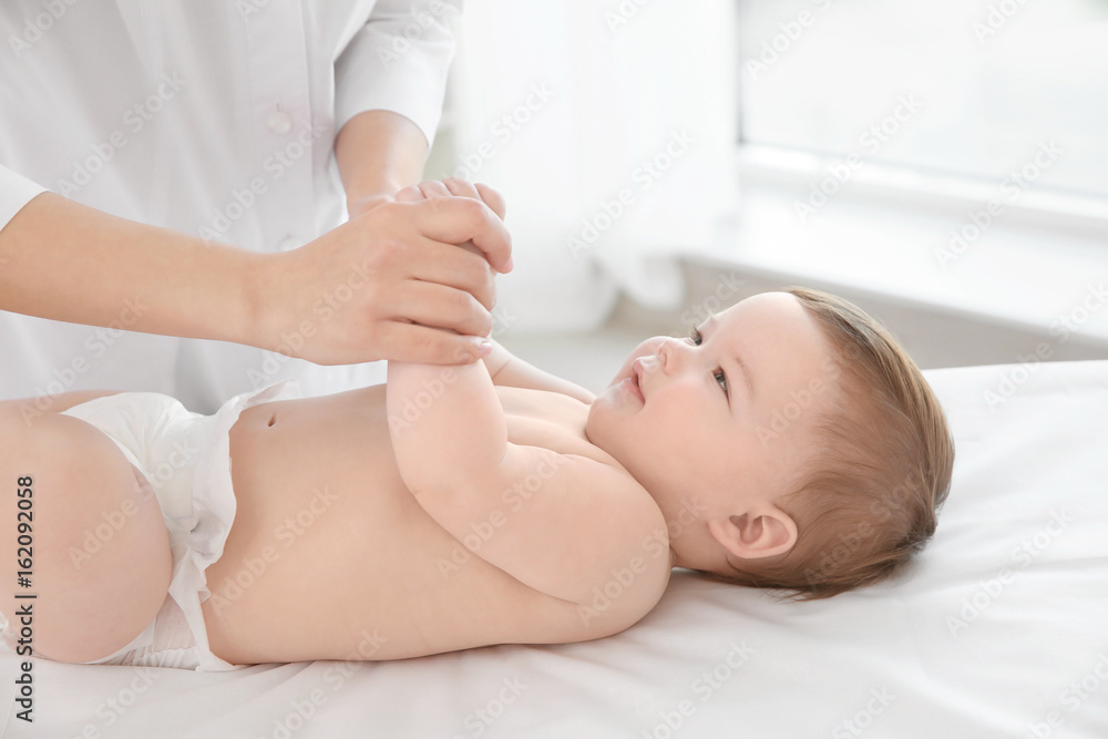 Doctor examining little baby in clinic. Baby health concept Doctor examining little baby in clinic. Baby health concept