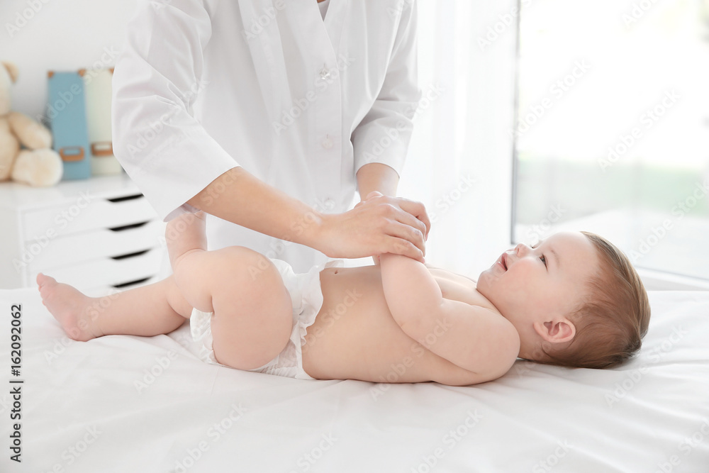 Doctor examining little baby in clinic. Baby health concept