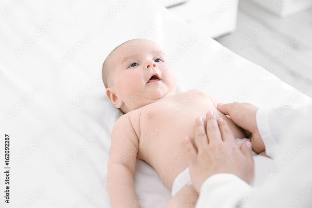 Doctor examining little baby in clinic. Baby health concept Doctor examining little baby in clinic. Baby health concept