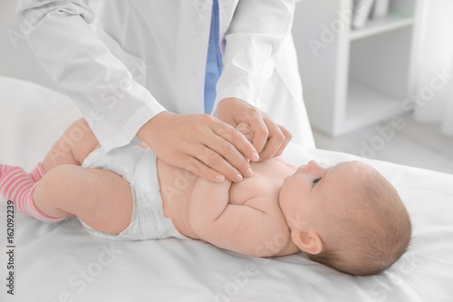 Doctor examining little bab...