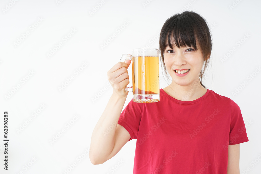Young woman cracking a beer after an exercise Young woman cracking a beer after an exercise