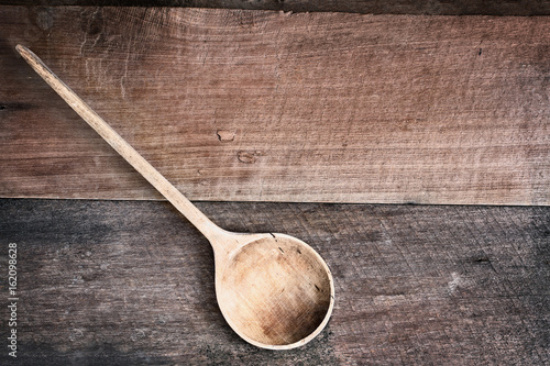 Wooden Spoon over Wood Background