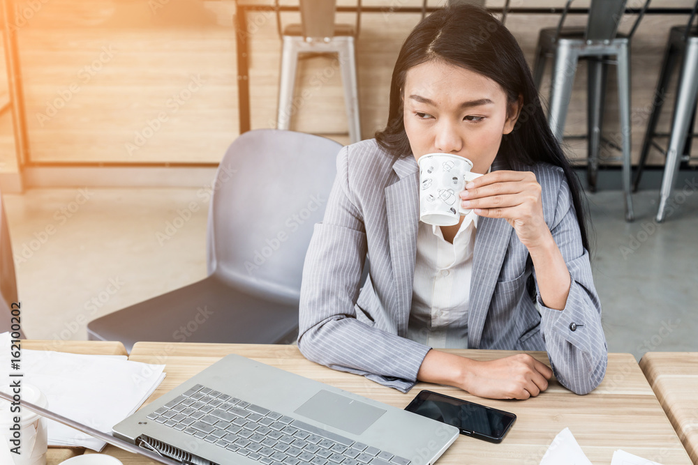 asian tan skin business woman drink hot coffee in the morning workday asian tan skin business woman drink hot coffee in the morning workday