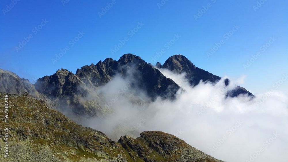 Mountains peaks over clouds