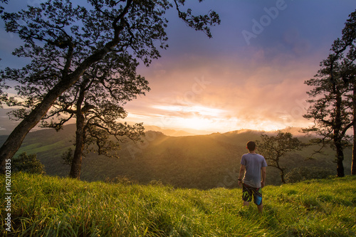 young man stand on mountain valley and enjoying sunset  © elbanco