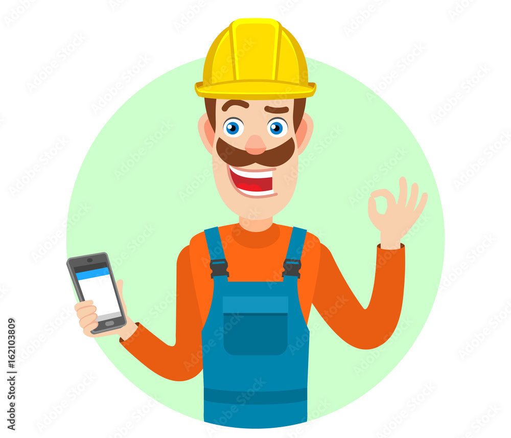 Builder holding mobile phone and showing a okay hand sign Builder holding mobile phone and showing a okay hand sign