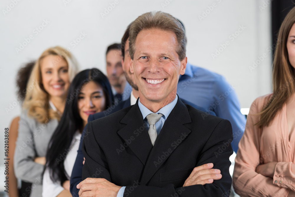 Successful Businessman Boss Over Businesspeople Group Background, Mature Leader With Business People Team Confident Hold Folded Hands Happy Smiling Successful Businessman Boss Over Businesspeople Group Background, Mature Leader With Business People Team Confident Hold Folded Hands Happy Smiling