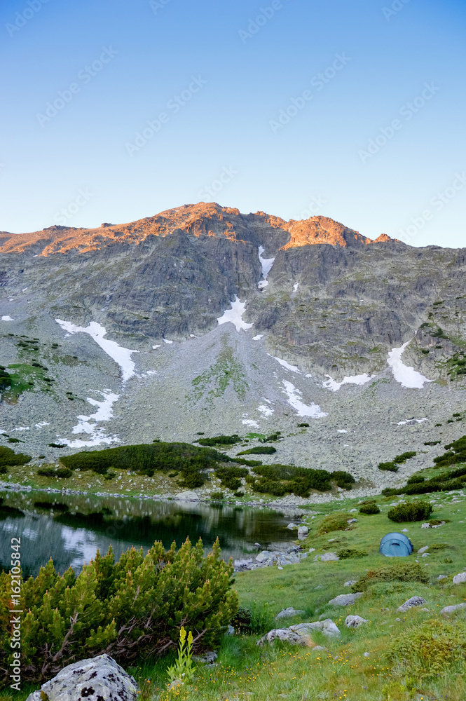 Tent near lake in mountains