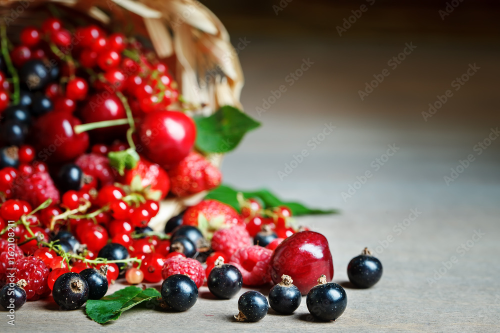 Ripe berries in a basket on a wooden table. Ripe berries in a basket on a wooden table.