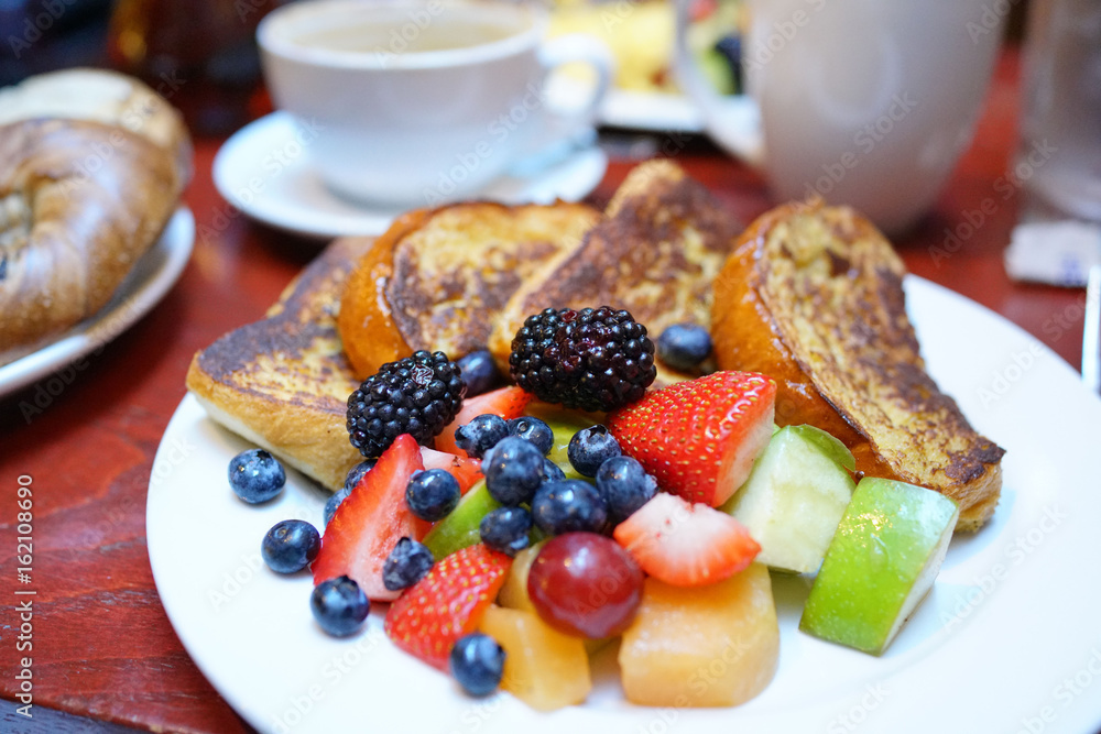 French toast with fruit salad set on restaurant table, NYC French toast with fruit salad set on restaurant table, NYC