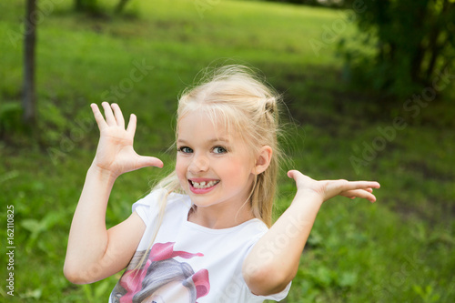 cheerful little girl outdoors   celebrate a birthday.  Cheerful children s holiday outdoors..