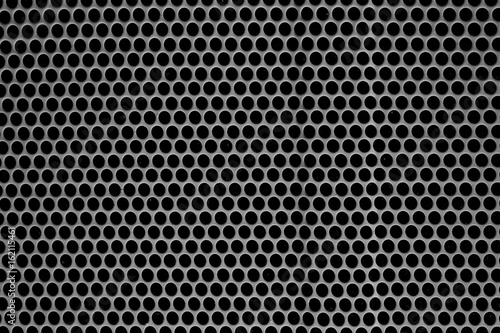 Metal texture with holes. A speaker grille.