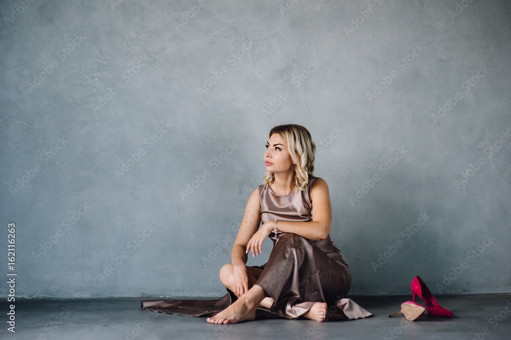 young woman in purple dress sitting on a floor young woman in purple dress sitting on a floor