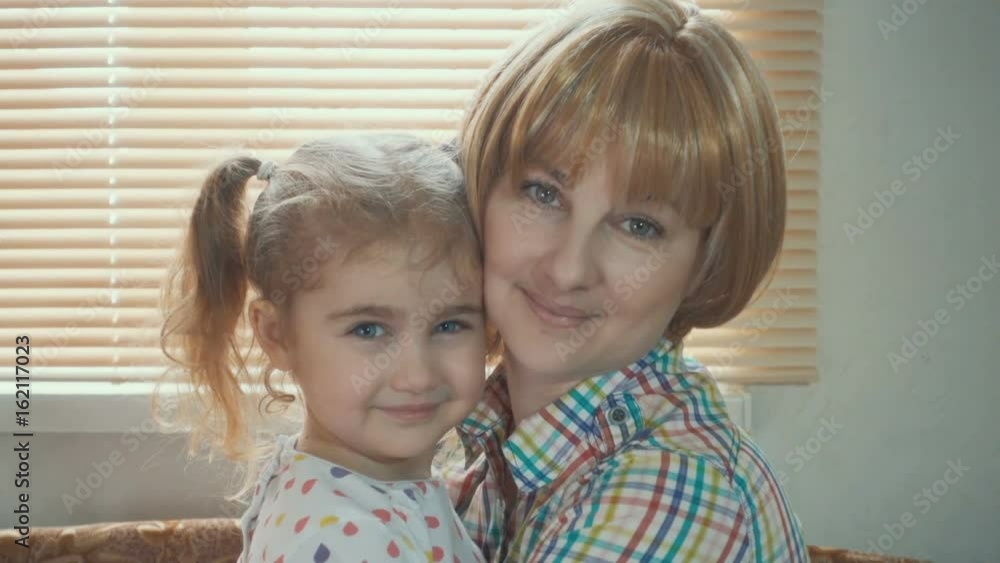 Daughter Rushes Into Mother's Arms At Home Across From the Window. Slow motion. Big Hug Daughter Rushes Into Mother's Arms At Home Across From the Window. Slow motion. Big Hug
