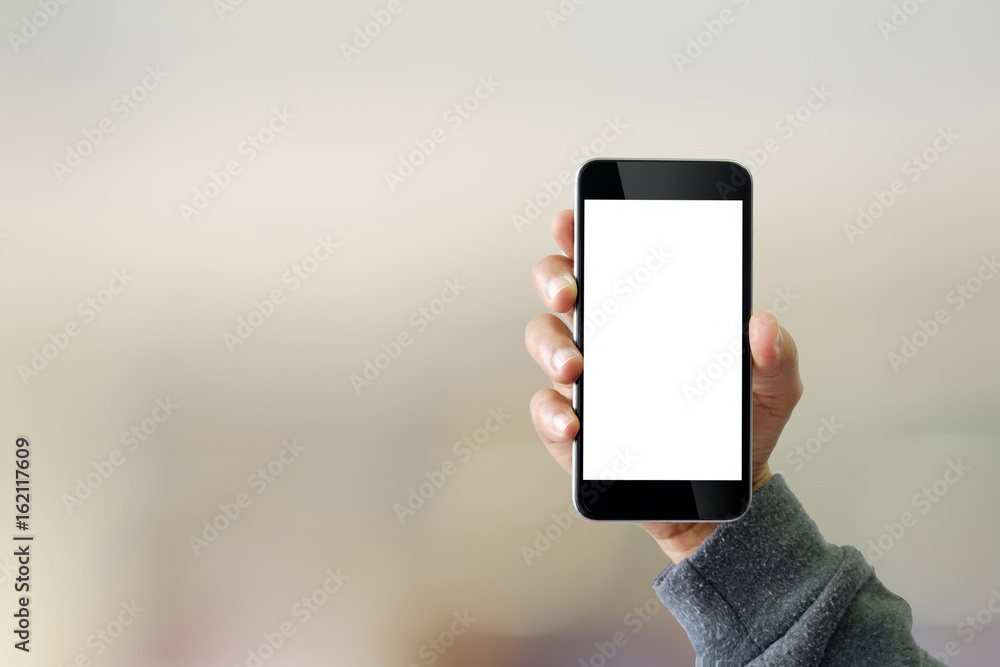 Man using smartphone on blur background.