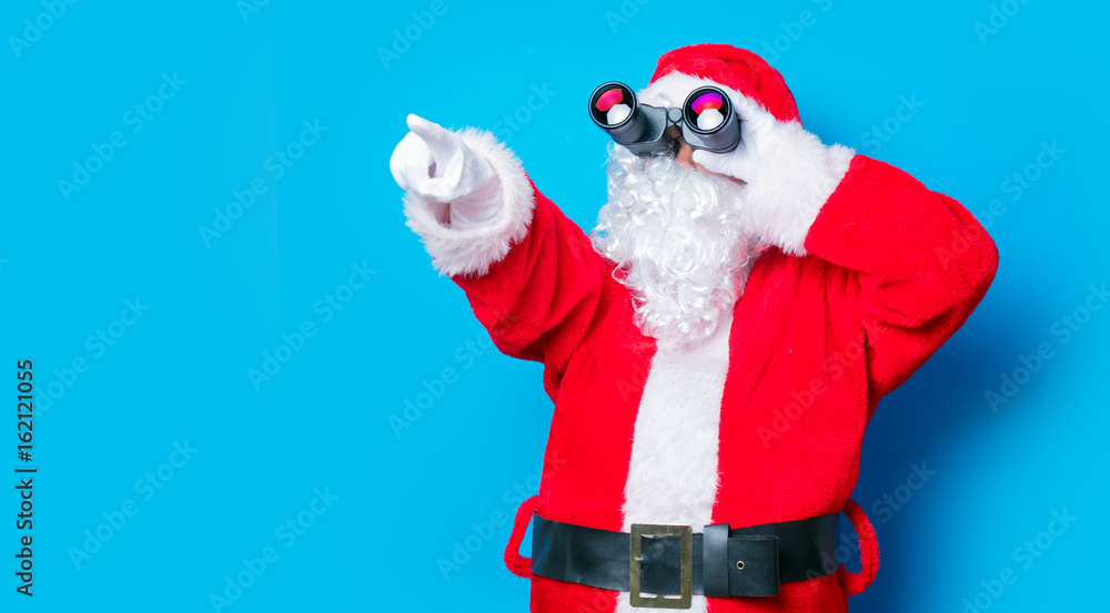 Funny Santa Claus have a fun with binoculars Funny Santa Claus have a fun with binoculars