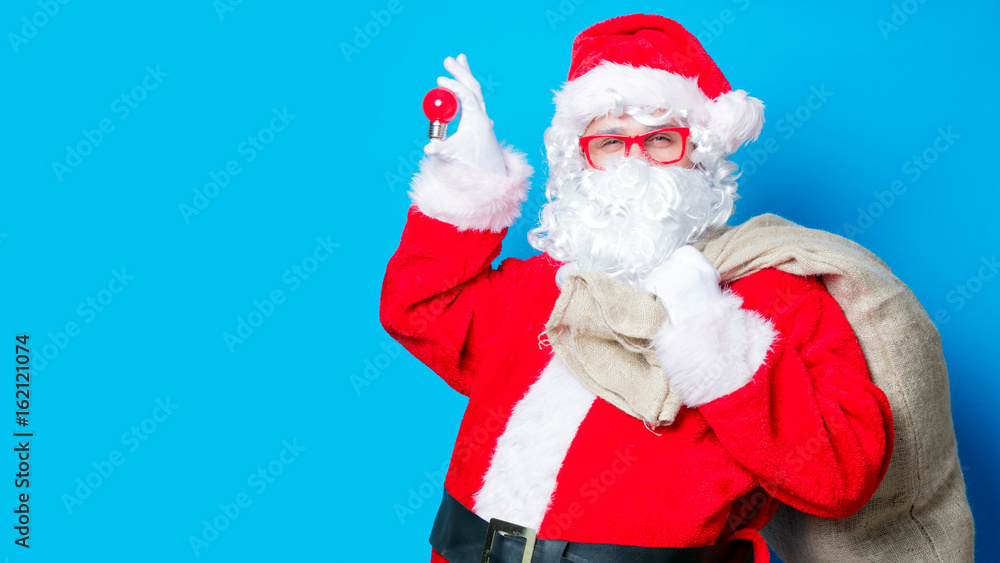 Funny Santa Claus have a fun with light bulb