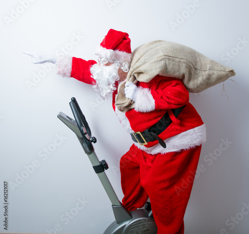 Santa Claus have a fun with Exercise Bikes