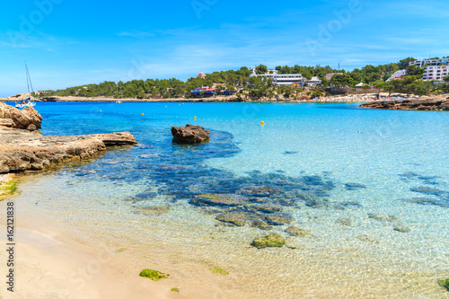 Idyllic Cala Portinatx beach with shallow crystal clear sea water  Ibiza island  Spain