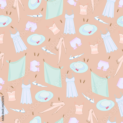 Pattern with women's clothes, a hat on a beige background