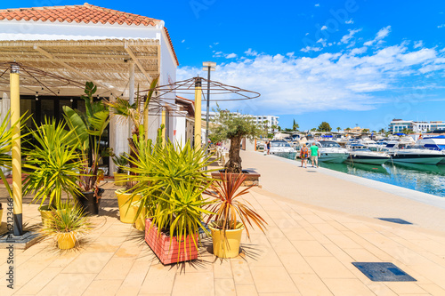Cafe decorated with tropical plants in Santa Eularia sailing marina on Ibiza island, Spain