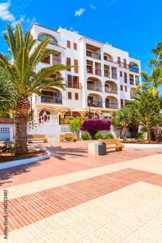 Promenade and apartments in traditional colonial Spanish style building in Santa Eularia town, Ibiza island, Spain