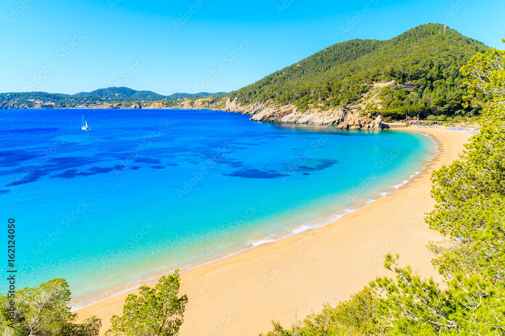 Amazing beach view with azure sea water in Cala San Vicente bay in northern part of Ibiza island, Spain