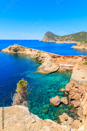 Sea cove with boat hosues in Punta Galera bay, Ibiza island, Spain