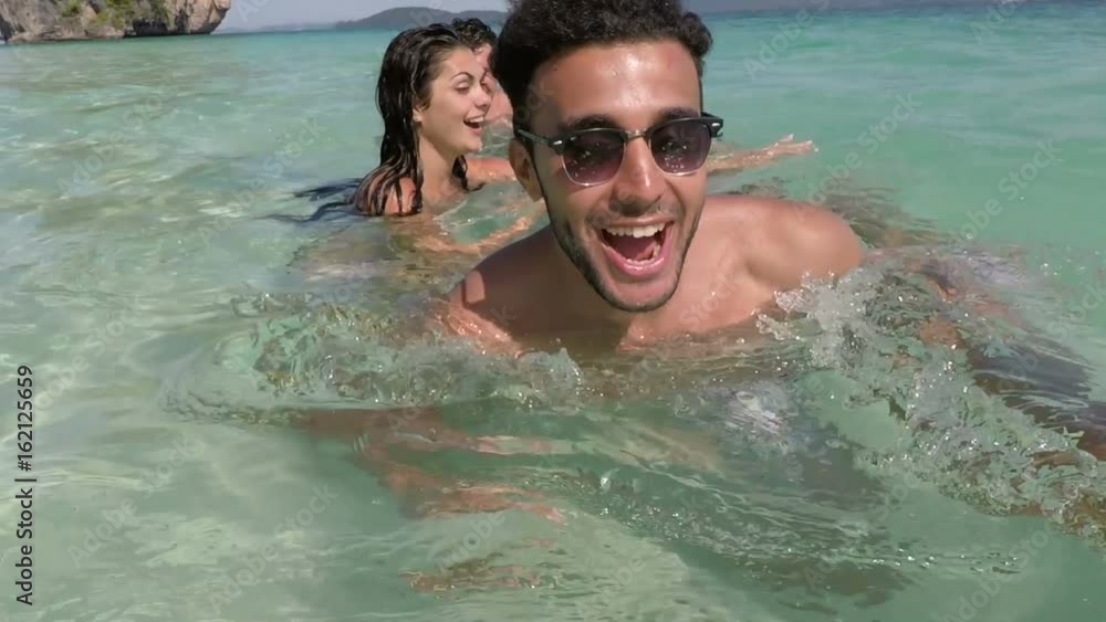 Happy People Group Faving Fun In Water Swimming In Sea On Beach POV, Cheerful Friends Tourists, Young Men And Women Holiday On Summer Sea Vacation Happy People Group Faving Fun In Water Swimming In Sea On Beach POV, Cheerful Friends Tourists, Young Men And Women Holiday On Summer Sea Vacation