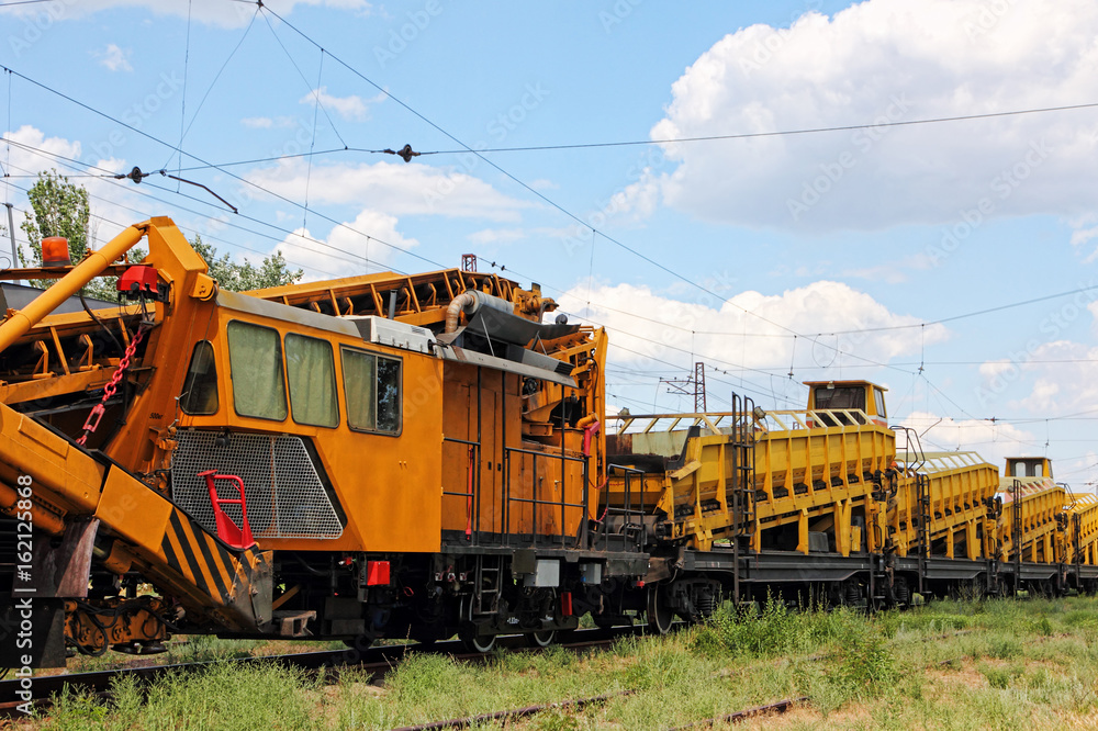 Orange Railway track service car.Crushed stone install construction machine. Orange Railway track service car.Crushed stone install construction machine.