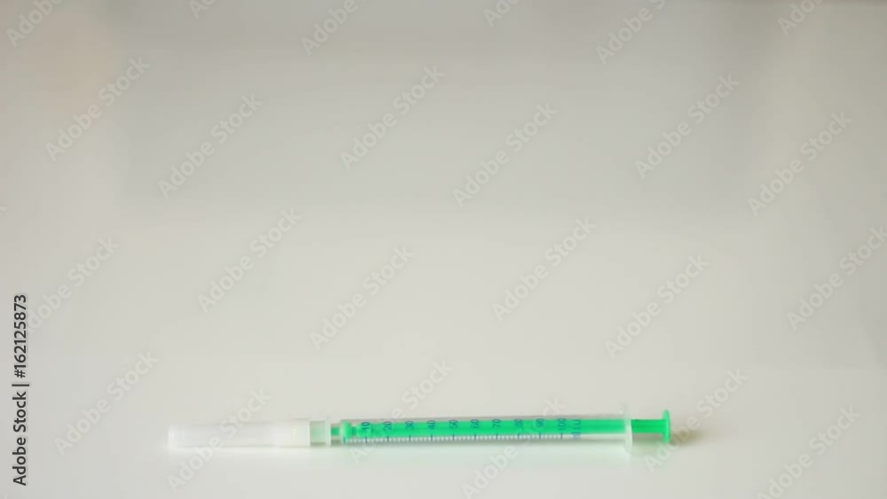 Putting alcohol, cotton and syringe Putting alcohol, cotton and syringe