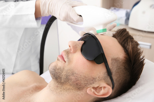Handsome man getting laser ...