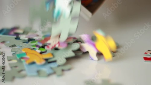 Pouring puzzle pieces from a box