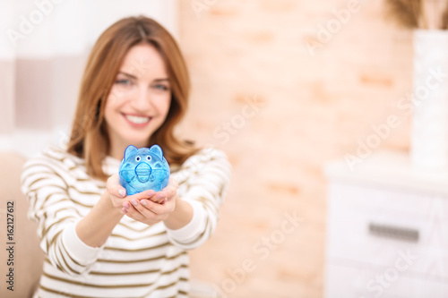 Happy young woman holding p...